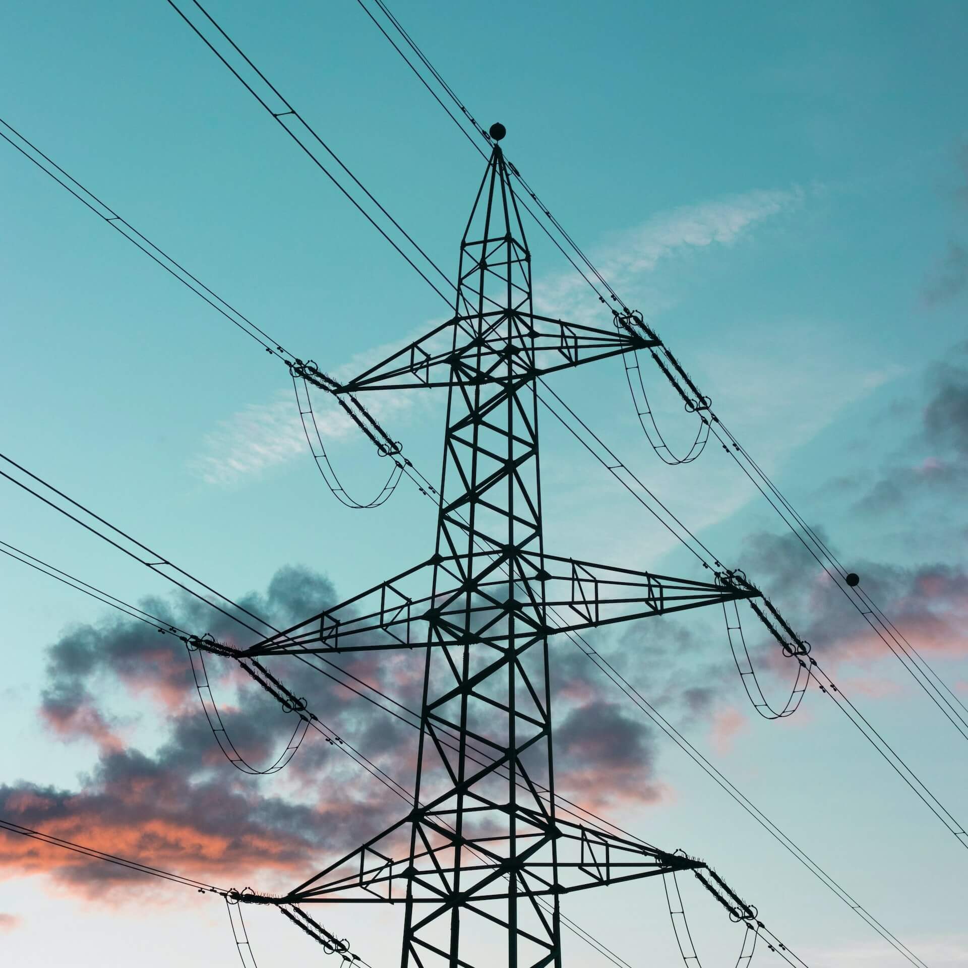 a power tower in the front with beautiful blue sky on the back